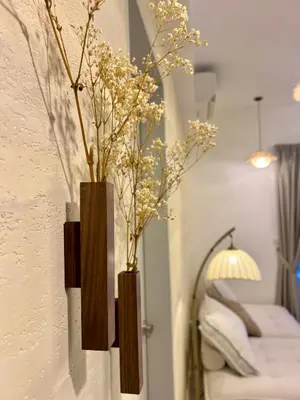 two vases with flowers in them on a wall at The Little Bali - Karaoke - 4 Pax in Kuala Lumpur