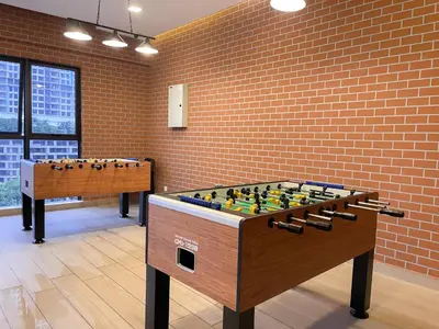 a foosball table in a room with a brick wall at The Little Bali - Karaoke - 4 Pax in Kuala Lumpur