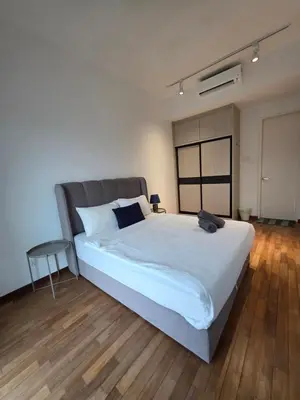 a bedroom with a large white bed and a table at Reizz Residence by Perkasa Suites in Batu Empat