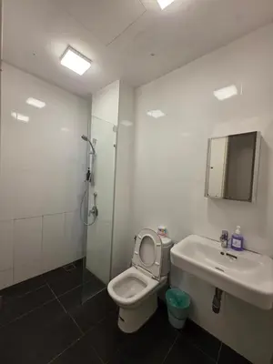 a bathroom with a toilet and a sink and a shower at Reizz Residence by Perkasa Suites in Batu Empat