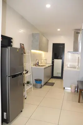 a kitchen with a stainless steel refrigerator in it at Reizz Residence by Perkasa Suites in Batu Empat