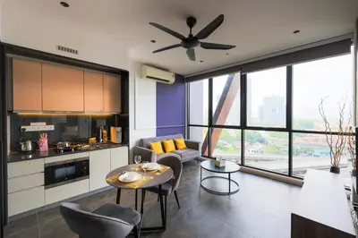 a kitchen and living room with a ceiling fan at Scarletz Suites KLCC by Minshuku in Kuala Lumpur
