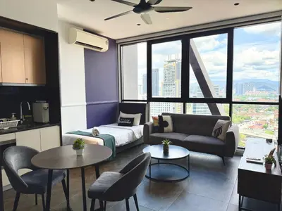 a living room with a couch and a table at Scarletz Suites KLCC by Minshuku in Kuala Lumpur
