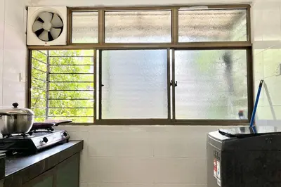 a kitchen with a stove and a large window at 3BR Family Stay at Desa Pandan KL ready Wifi Netflix in Kuala Lumpur