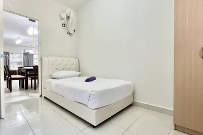 a bedroom with a white bed with a purple pillow on it at 3BR Family Stay at Desa Pandan KL ready Wifi Netflix in Kuala Lumpur