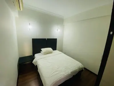 a small room with a white bed in it at place to stay At Bukit Bintang in Kuala Lumpur
