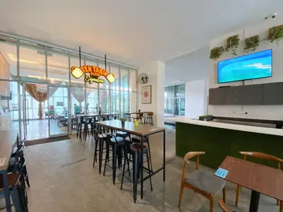 a restaurant with a bar and tables and chairs at Awesomestay Hostel near KLCC , walk to PWTC PUTRA in Kuala Lumpur