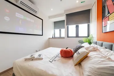 a bedroom with a bed with two pumpkins on it at Riveria City KL Sentral by Sleepy Bear in Kuala Lumpur