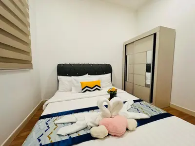a bedroom with two stuffed animals laying on a bed at Velocity Residence linkway Sunway mall in Kuala Lumpur