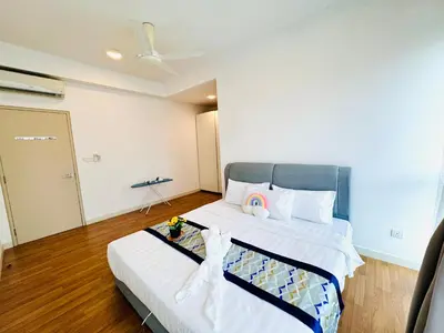 a bedroom with a bed with a blue headboard at Velocity Residence linkway Sunway mall in Kuala Lumpur