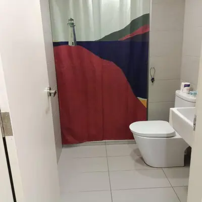 a bathroom with a red shower curtain and a toilet at EkoCheras max5pax Romance Retreats #freeparking #netflix #wifi in Kuala Lumpur