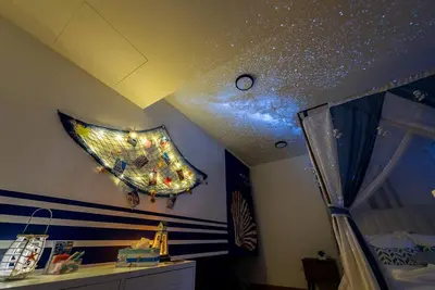 a kite with lights on the ceiling of a bedroom at EkoCheras max5pax Romance Retreats #freeparking #netflix #wifi in Kuala Lumpur