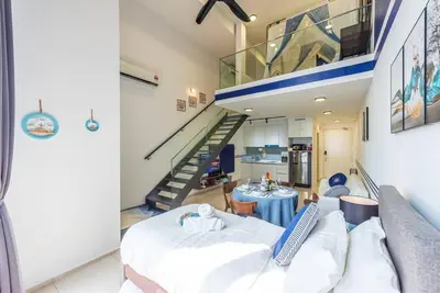 a living room with a couch and a staircase at EkoCheras max5pax Romance Retreats #freeparking #netflix #wifi in Kuala Lumpur