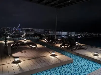 a rooftop pool at night with chairs and lights at EkoCheras max5pax Romance Retreats #freeparking #netflix #wifi in Kuala Lumpur