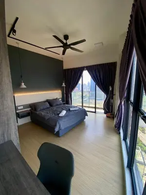 a bedroom with a bed and a ceiling fan at TOP FLOOR 3BR apartment in KL for 6Pax in Kuala Lumpur