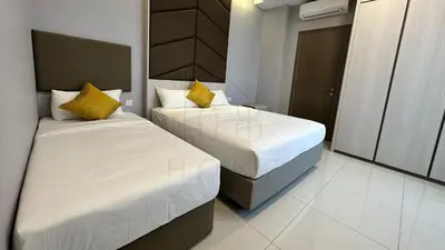 a bedroom with two beds with yellow pillows at Societe Suites 108 Hartamas Mont Kiara Kuala Lumpur 2-6pax in Kuala Lumpur
