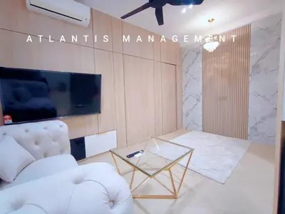 a living room with a white couch and a glass table at Arte Mont Kiara in Kuala Lumpur