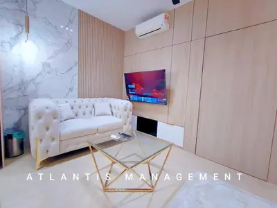 a living room with a white couch and a table at Arte Mont Kiara in Kuala Lumpur
