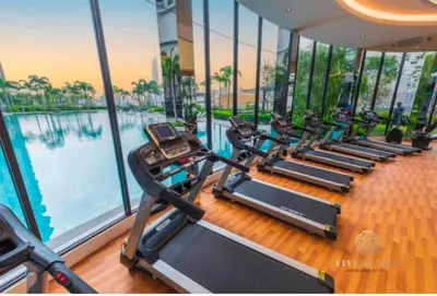 a row of treadmills in a gym next to a pool at Trion by sweet home in Kuala Lumpur