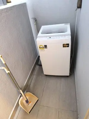 a small refrigerator in a room with a broom at Trion By Awesome Apartment Stay in Kuala Lumpur
