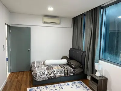 a small room with a bed and a window at Summer Suites KLCC in Kuala Lumpur