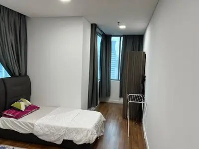 a bedroom with a bed and a large window at Summer Suites KLCC in Kuala Lumpur
