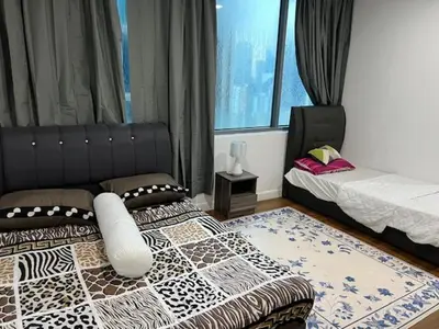 a bedroom with two beds and a window at Summer Suites KLCC in Kuala Lumpur