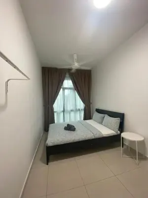 a bedroom with a bed and a window at KLCC Skyhomes near LRT in Kuala Lumpur