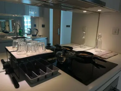a kitchen with a counter with glasses and a stove at Vortex Hotel Suites & Residence by KLCC in Kuala Lumpur