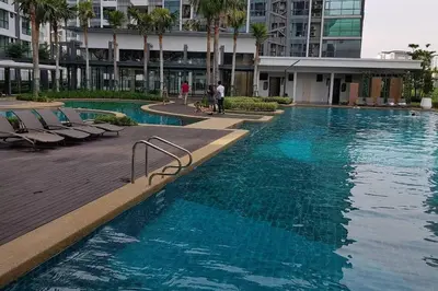 a large swimming pool with blue water in a building at V Residence Suite at Sunway Velocity in Kuala Lumpur