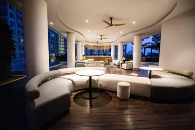a living room with a large couch and tables at V Residence Suite at Sunway Velocity in Kuala Lumpur