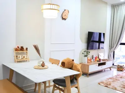 a teddy bear sitting on a table in a living room at Capybara Trion KL View in Kuala Lumpur