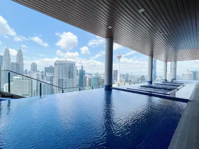a swimming pool on the top of a building with a city skyline at Colony Infinitum By NJ Homes in Kuala Lumpur
