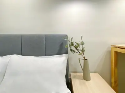a vase sitting on a table next to a bed at Colony Infinitum By NJ Homes in Kuala Lumpur