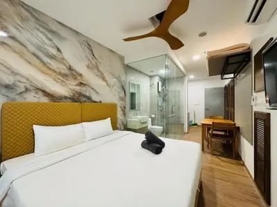 a bedroom with a bed with a black cat sitting on it at Awesomestay apartment walk to Tun Sambathan near KL Sentral in Kuala Lumpur