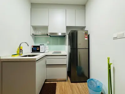 a kitchen with white cabinets and a stainless steel refrigerator at Awesomestay apartment walk to Tun Sambathan near KL Sentral in Kuala Lumpur