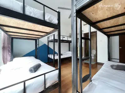 a room with three bunk beds in a room at NJ Homestay Hostel at Regalia Residence in Kuala Lumpur