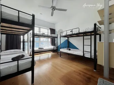 a room with three bunk beds and a ceiling fan at NJ Homestay Hostel at Regalia Residence in Kuala Lumpur