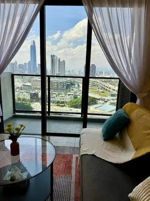 a living room with a glass table and a large window at trion2 klcc in Kuala Lumpur