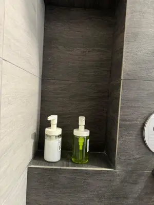 two bottles of soap sitting on a shelf in a bathroom at trion2 klcc in Kuala Lumpur