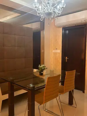 a dining room table with chairs and a chandelier at Chelsea Residence Studio, Plaza Damas 3 in Kuala Lumpur