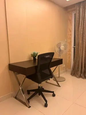 a desk with a chair and a fan in a room at Chelsea Residence Studio, Plaza Damas 3 in Kuala Lumpur