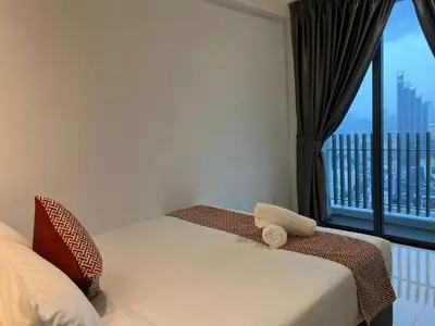 a bedroom with a bed and a window with a view at The Colony By Infinitum KLCC in Kuala Lumpur