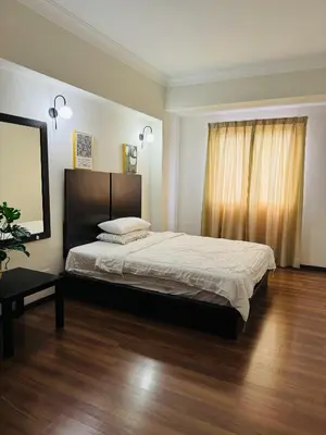 a bedroom with a large bed and a wooden floor at Homestay Room near KLCC in Kuala Lumpur