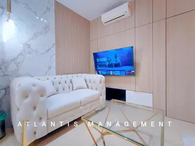 a living room with a white couch and a tv at Arte Mon Kiara MK3 Royal Stylist Apartment, Walking Distance to Publika in Kuala Lumpur
