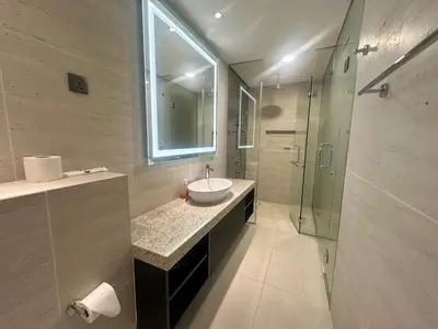 a bathroom with a sink and a glass shower at Holiday Suites at Star in Kuala Lumpur