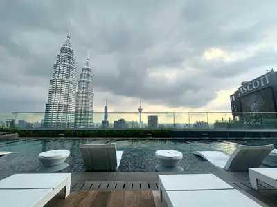 a view of the petronas twin skyscrapers from a rooftop at Holiday Suites at Star in Kuala Lumpur