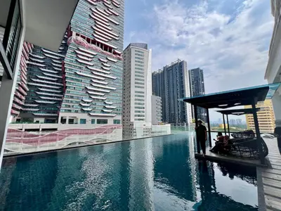 a pool in a city with tall buildings at Dreamscape By Reizz Residence in Kuala Lumpur