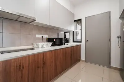a kitchen with a counter with a sink and a microwave at 4BR Modish Room MVertica Near MRT by RumaBnB in Kuala Lumpur