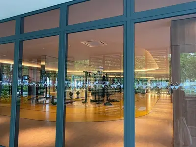 a gym in a building with a large window at 4BR Modish Room MVertica Near MRT by RumaBnB in Kuala Lumpur